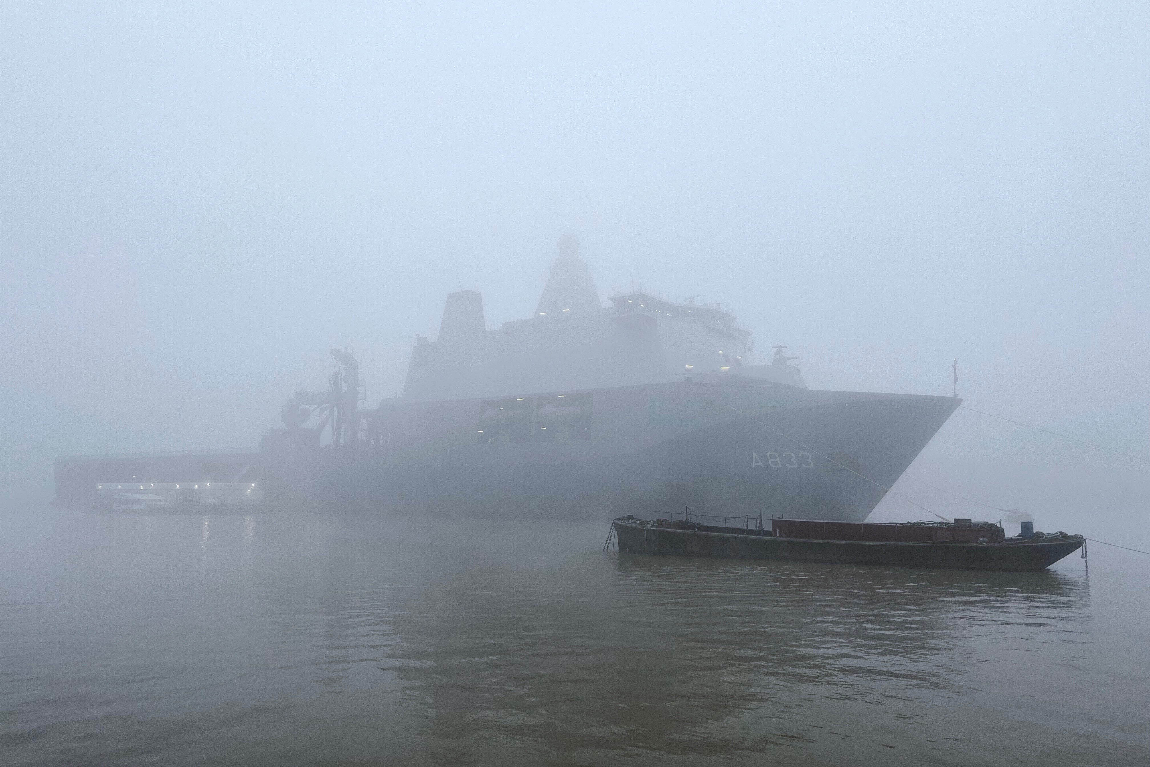 A Dutch Royal Naval vessel, the HNLMS Karel Doorman, moored on the Thames at Greewnwich, in the fog